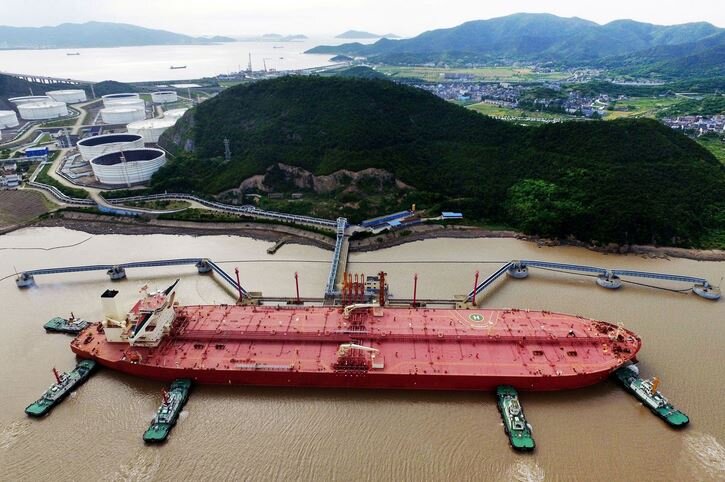Massive Oil Tanker Docked at Coastal Refinery Terminal /oil tanker , refinery , energy infrastructure , maritime transport , crude oil