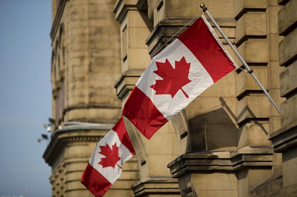 Canadian Flags Fly on Government Building /Canada , flag , government , building , maple leaf